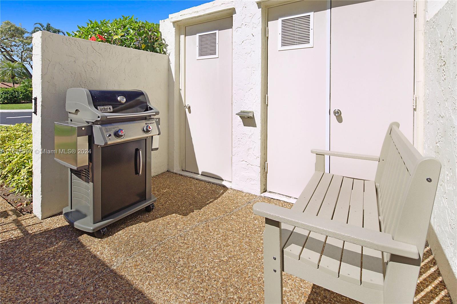 7864 Granada Place, Unit 504 Boca Raton, FL 33433 - Photo 3 of 65 a view of a kitchen with an entryway and a wooden floor