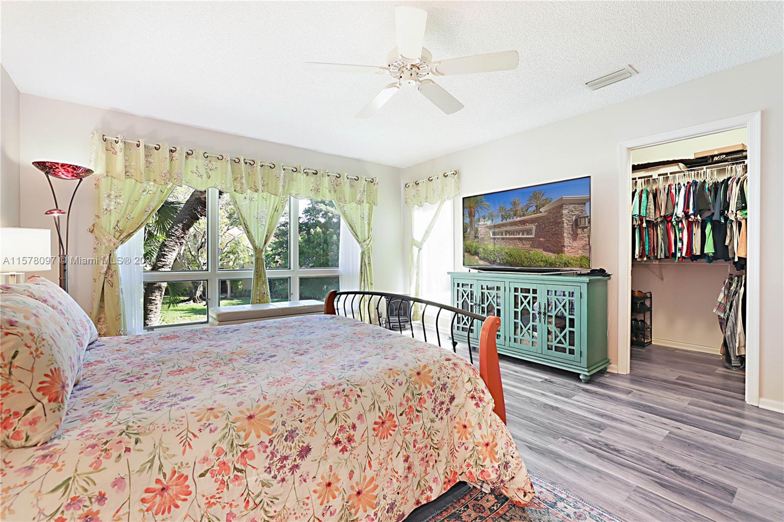 7864 Granada Place, Unit 504 Boca Raton, FL 33433 - Photo 32 of 65 a bedroom with furniture and a flat screen tv