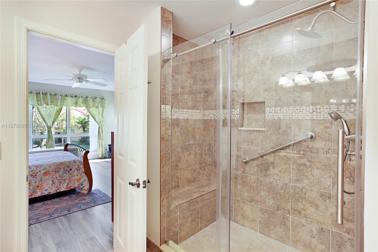 7864 Granada Place, Unit 504 Boca Raton, FL 33433 - Photo 35 of 65 a bathroom with a glass shower door and a glass door shower