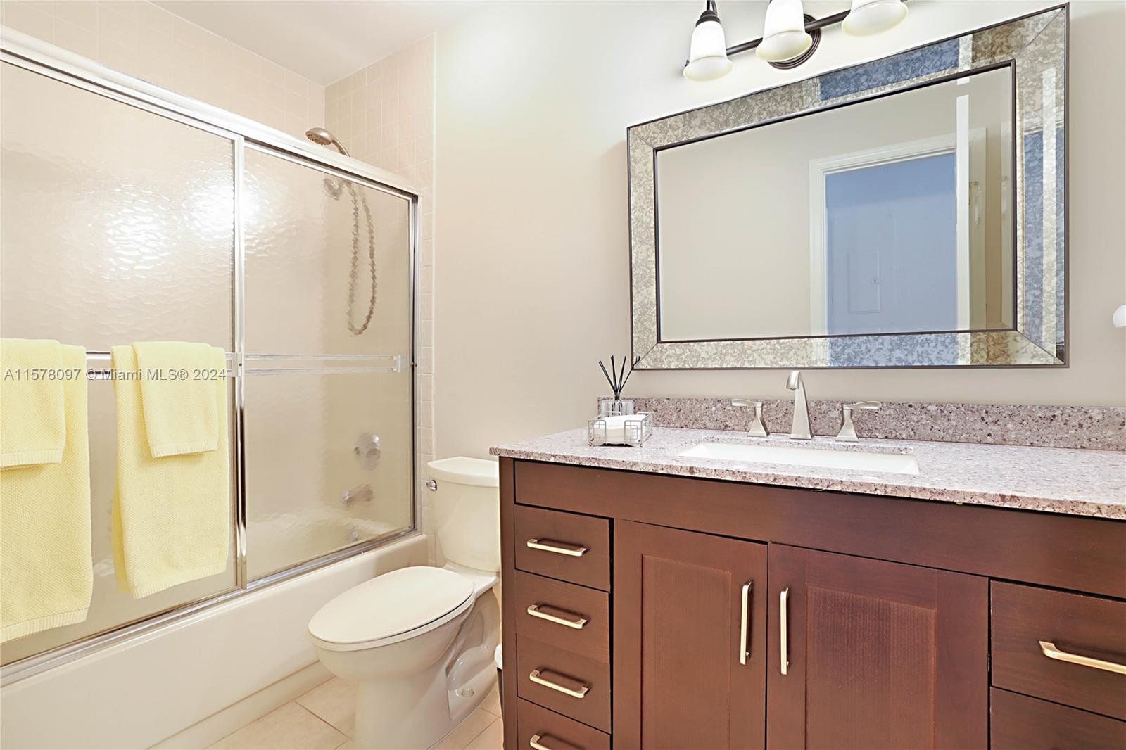 7864 Granada Place, Unit 504 Boca Raton, FL 33433 - Photo 38 of 65 a bathroom with a granite countertop sink toilet and shower