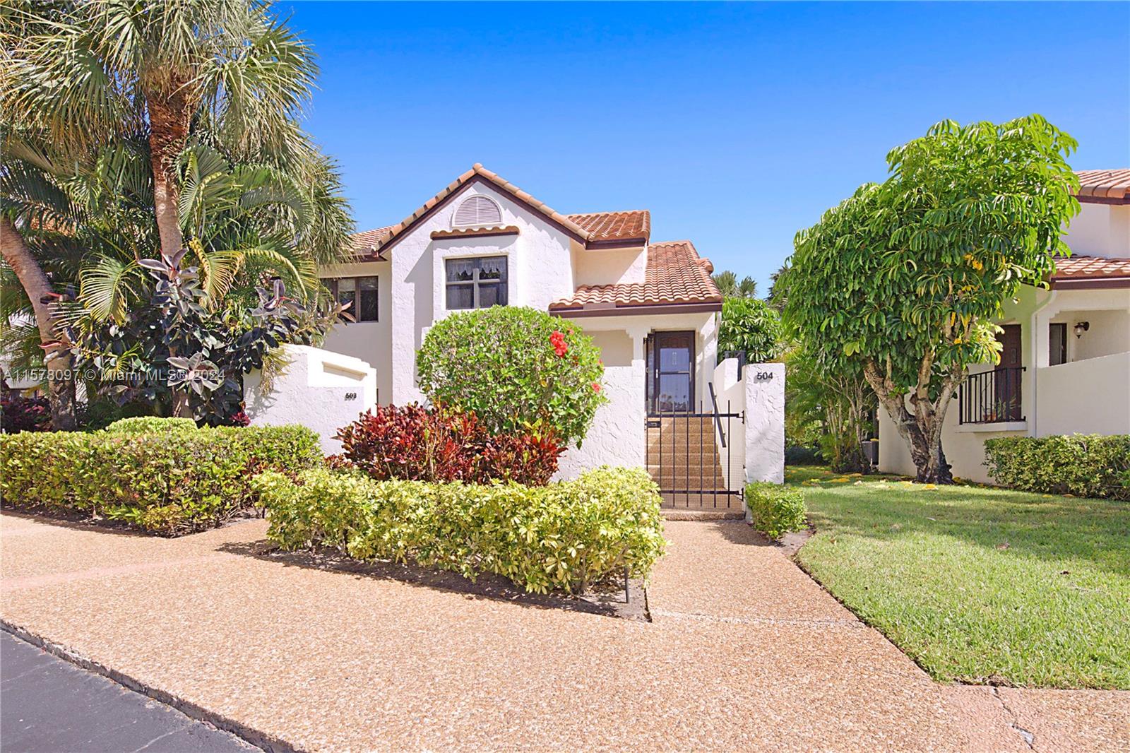 7864 Granada Place, Unit 504 Boca Raton, FL 33433 - Photo 40 of 65 a front view of a house with a yard