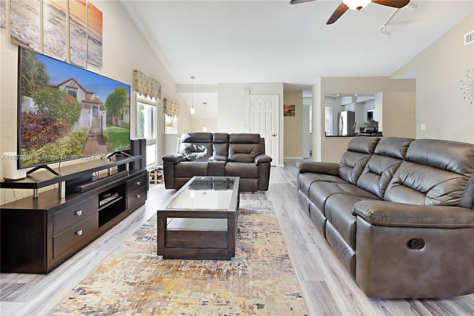 7864 Granada Place, Unit 504 Boca Raton, FL 33433 - Photo 10 of 65 a living room with furniture and a flat screen tv