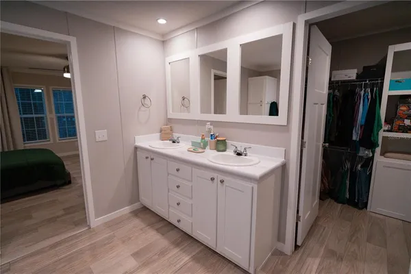 a bathroom with a double vanity sink and a mirror