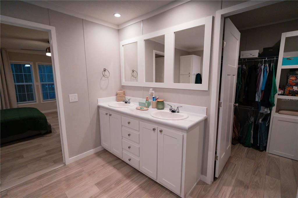 7670 Northeast 97th Court Bronson, FL 32621 - Photo 13 of 58 a bathroom with a double vanity sink and a mirror