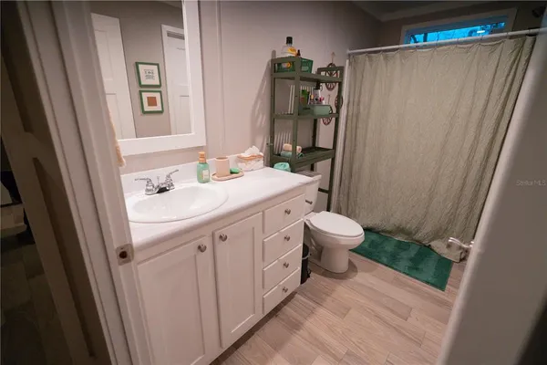 a bathroom with a toilet a sink and a mirror