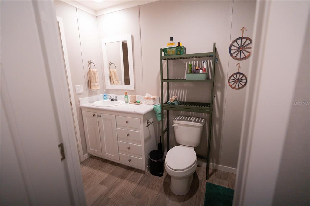 7670 Northeast 97th Court Bronson, FL 32621 - Photo 22 of 58 a bathroom with a toilet a sink and a mirror