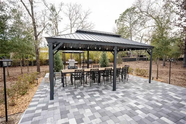 a view of a patio with furniture and a yard