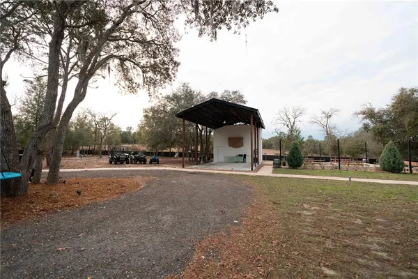 a view of a park with swings and a slide