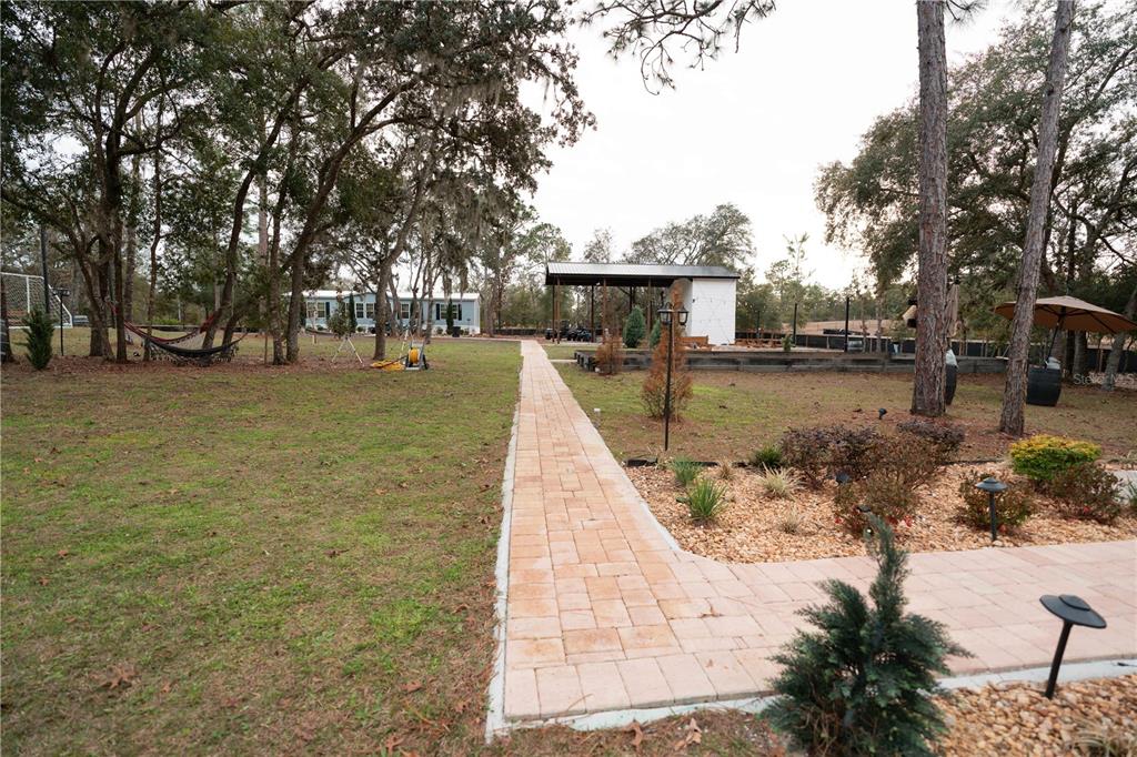7670 Northeast 97th Court Bronson, FL 32621 - Photo 38 of 58 a view of a yard with trees
