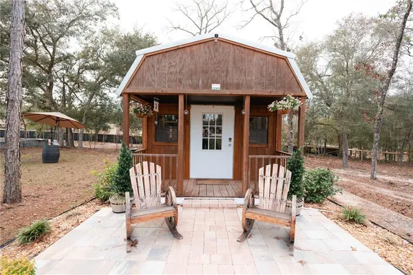 a swimming pool with trees in the background