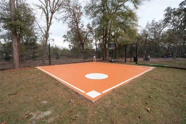 a view of dirt yard with a trees