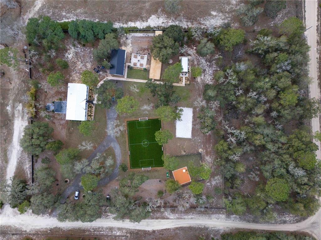 7670 Northeast 97th Court Bronson, FL 32621 - Photo 57 of 58 a front view of a house with a yard