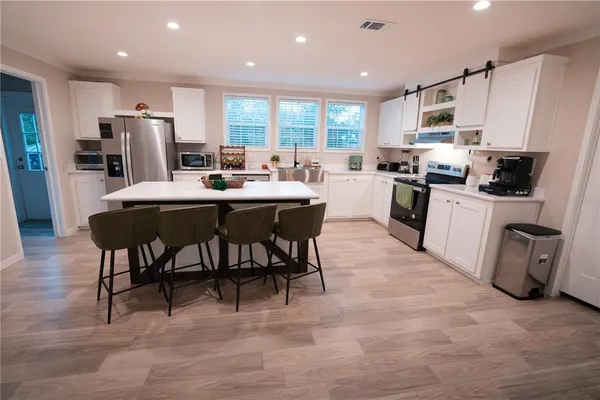 a kitchen with counter space appliances and a dining table