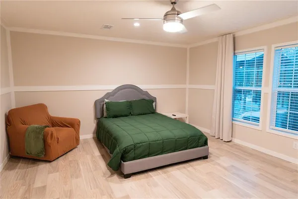 a bedroom with a bed and a large window