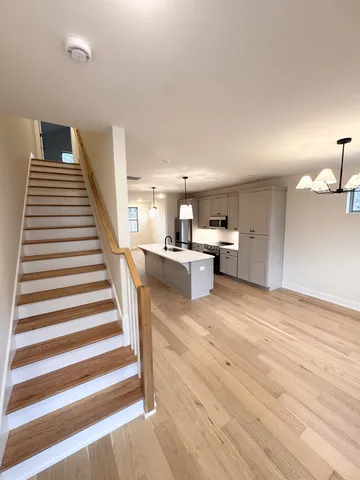 a view of kitchen and hall with wooden floor
