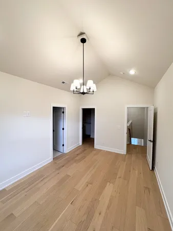 a view of a room with an empty room and chandelier