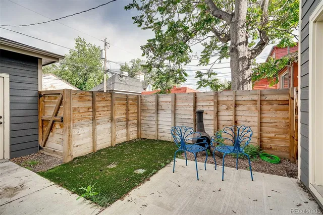 a view of a chair and table in backyard