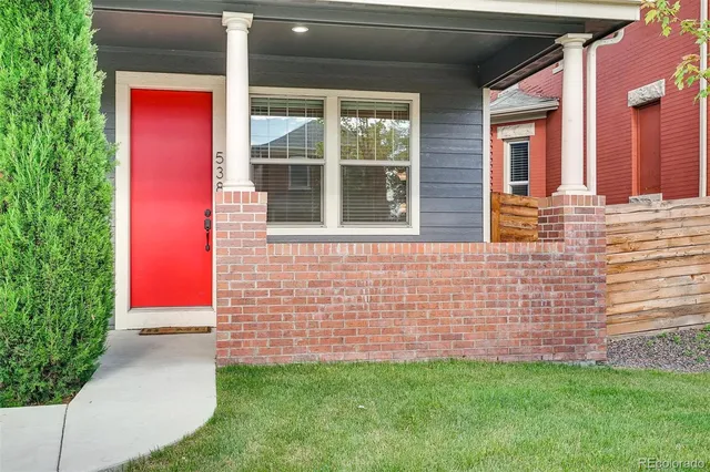 a view of a brick house with a yard
