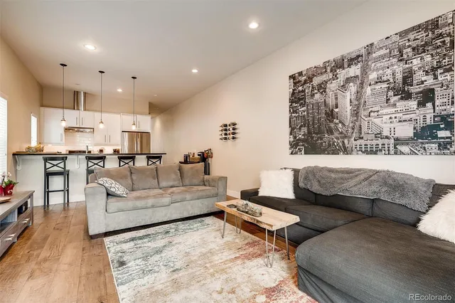 a living room with furniture and kitchen view