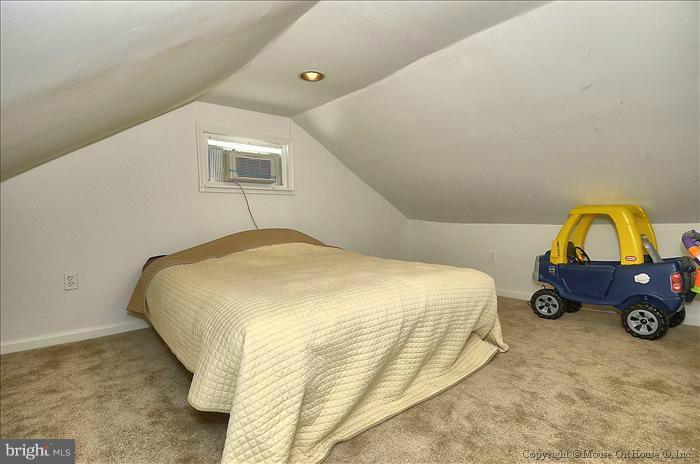 11708 Idlewood Road Silver Spring, MD 20906 - Photo 12 of 21 a bedroom with a bed and a parked cars