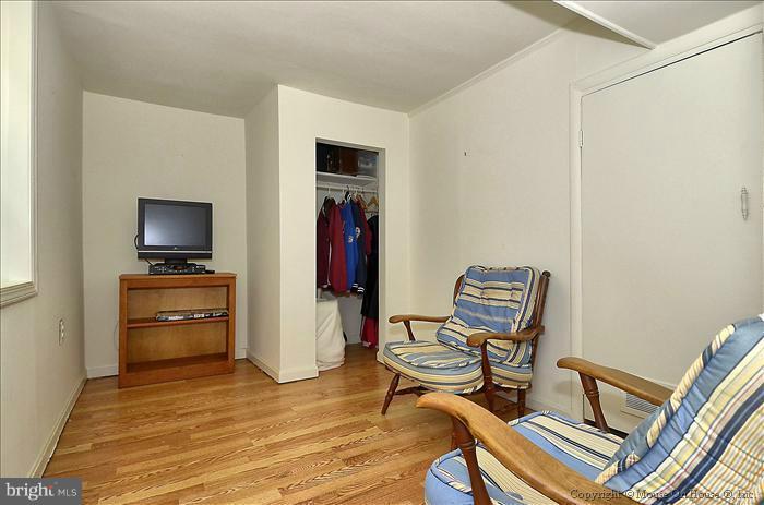 11708 Idlewood Road Silver Spring, MD 20906 - Photo 17 of 21 a room with furniture and a flat screen tv
