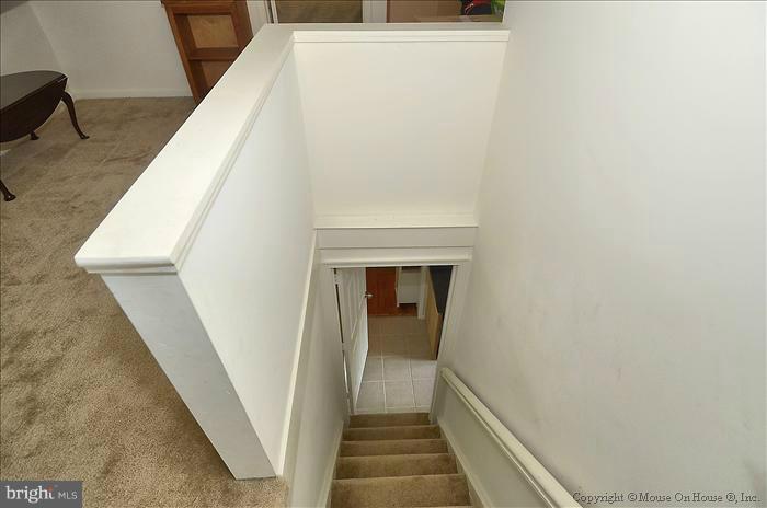 11708 Idlewood Road Silver Spring, MD 20906 - Photo 20 of 21 a view of a hallway with wooden floor and staircase
