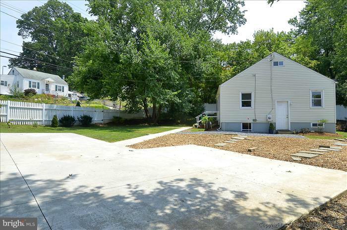 11708 Idlewood Road Silver Spring, MD 20906 - Photo 4 of 21 a view of a house with a yard and large trees