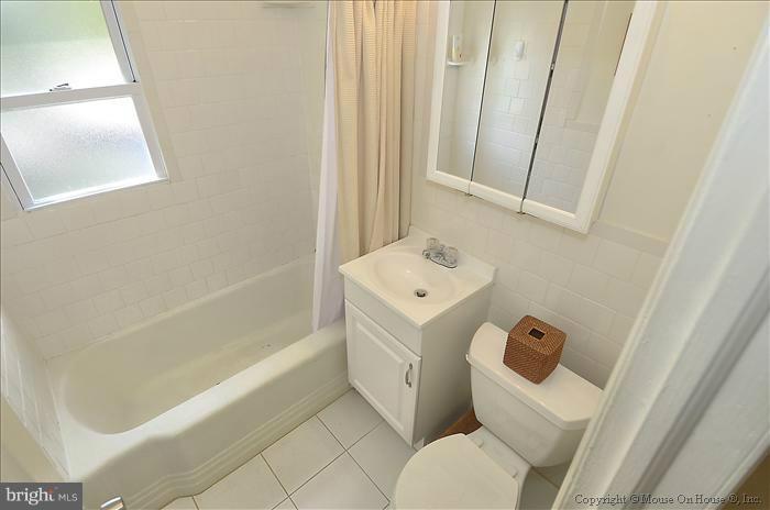 11708 Idlewood Road Silver Spring, MD 20906 - Photo 7 of 21 a bathroom with a bathtub sink and toilet
