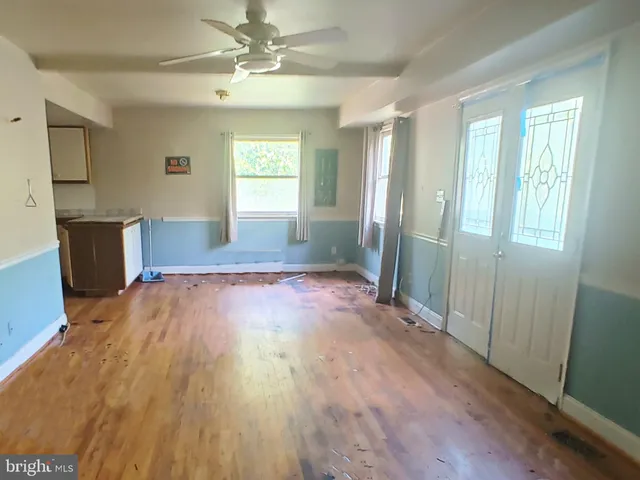 a view of livingroom with hardwood floor and a ceiling fan