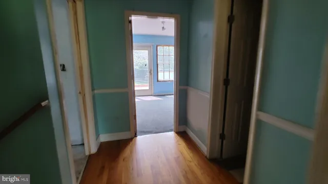 a view of hallway with wooden floor