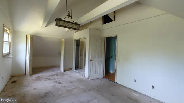 a view of a hallway with wooden shelves