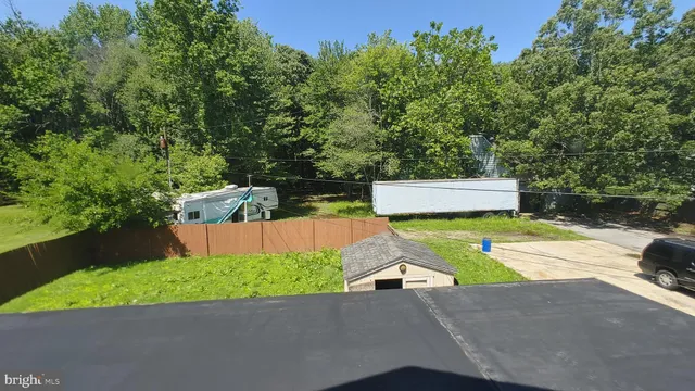a view of backyard with swimming pool and seating space