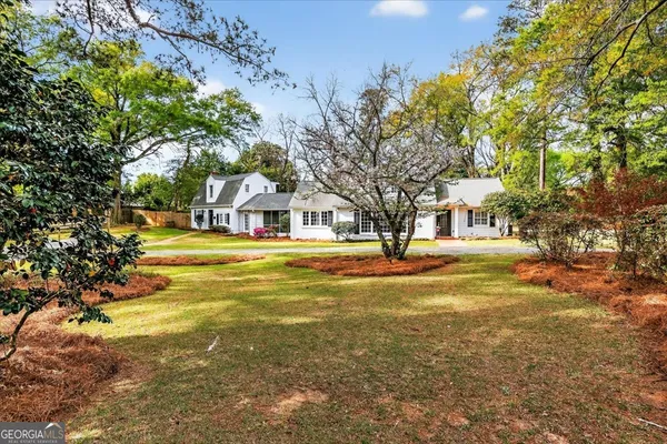 a view of a room with wooden floor and windows
