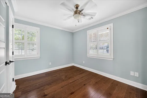 a kitchen with stainless steel appliances granite countertop a stove top oven a sink dishwasher and wooden cabinets with wooden floor