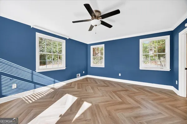 a living room with stainless steel appliances kitchen island granite countertop a stove a sink and a refrigerator with wooden cabinets