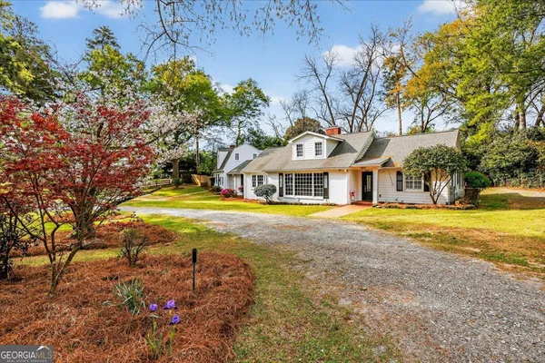 a view of house with outdoor space and swimming pool