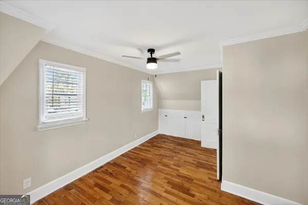 a front view of a house with a garden and yard