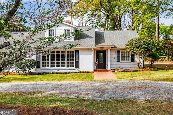 a view of a house with swimming pool and sitting area