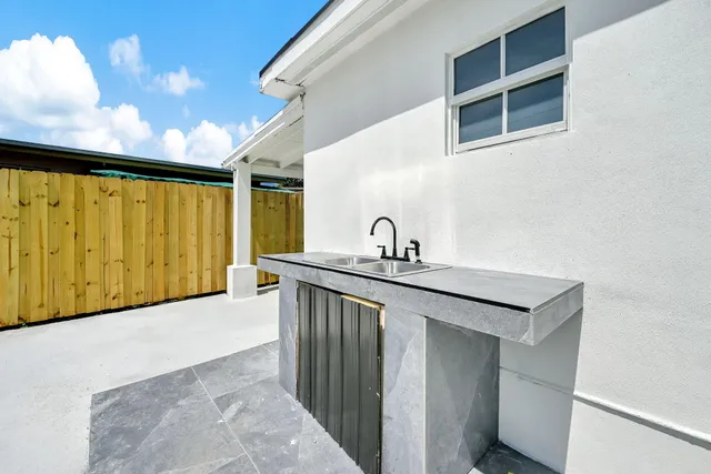 a kitchen with a sink cabinets and a window