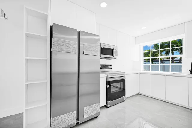 a kitchen with a white cabinets and a sink