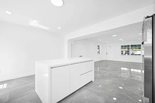 a view of a kitchen with a refrigerator and a cabinets