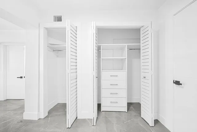 a bathroom with a toilet sink vanity and mirror