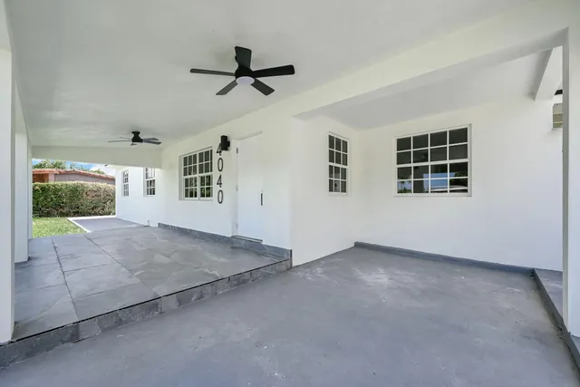 a view of empty room with windows and ceiling fan view