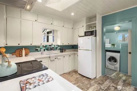 a kitchen with a refrigerator sink and cabinets