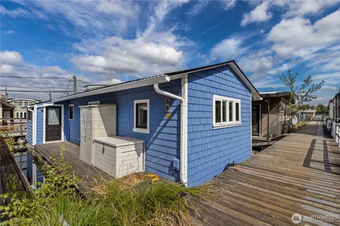 a view of a house with wooden fence