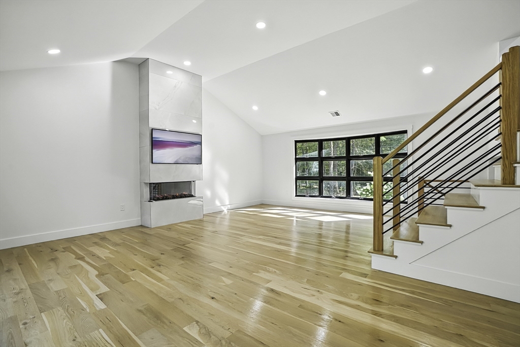 68 Pearl Street Upton, MA 01568 - Photo 14 of 37 a view of an empty room with a window and wooden floor