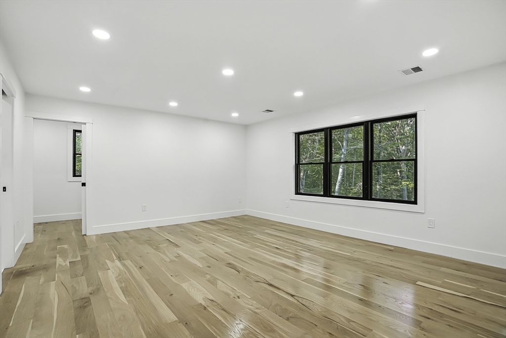 68 Pearl Street Upton, MA 01568 - Photo 24 of 37 a view of an empty room with wooden floor and a window