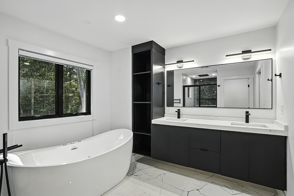 68 Pearl Street Upton, MA 01568 - Photo 28 of 37 a bathroom with a bathtub sink double vanity and a mirror