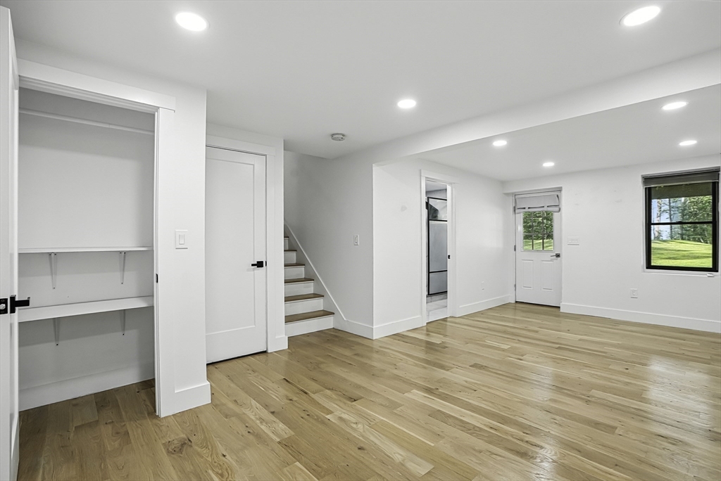 68 Pearl Street Upton, MA 01568 - Photo 29 of 37 a view of an empty room with a window and wooden floor