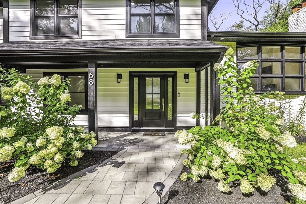 68 Pearl Street Upton, MA 01568 - Photo 3 of 37 a front view of a house with a lots of potted plants